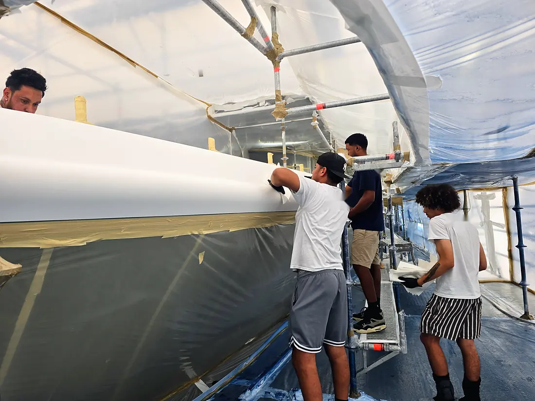 Hand sanding the hull side between coats